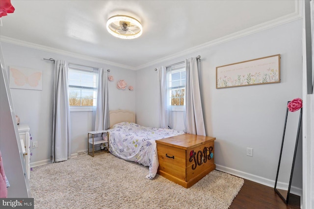 bedroom with baseboards, multiple windows, and crown molding