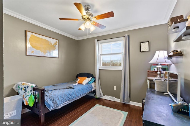 bedroom featuring visible vents, ceiling fan, baseboards, ornamental molding, and wood finished floors