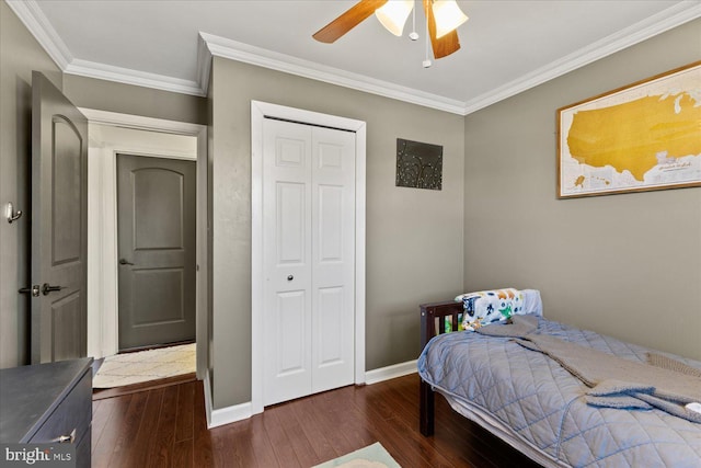 bedroom featuring a closet, crown molding, baseboards, and hardwood / wood-style flooring