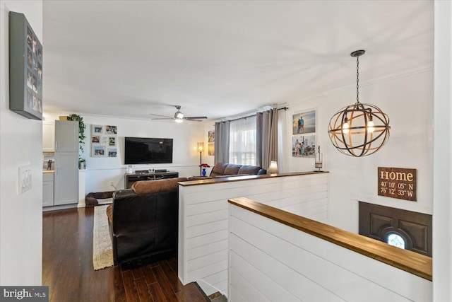 living area featuring dark wood-type flooring and ceiling fan