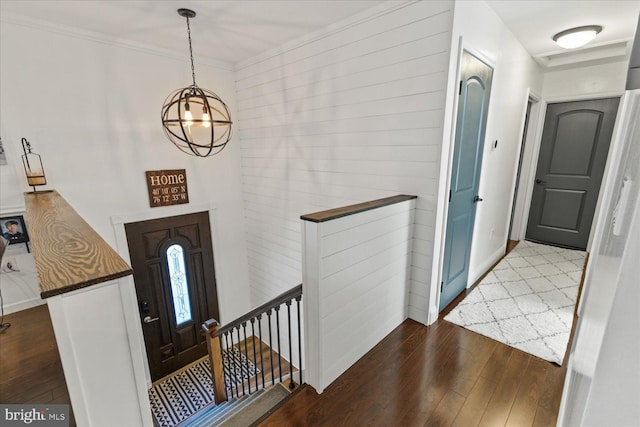 entrance foyer featuring hardwood / wood-style flooring, baseboards, and ornamental molding