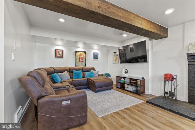 living room with wood finished floors, visible vents, baseboards, recessed lighting, and beamed ceiling