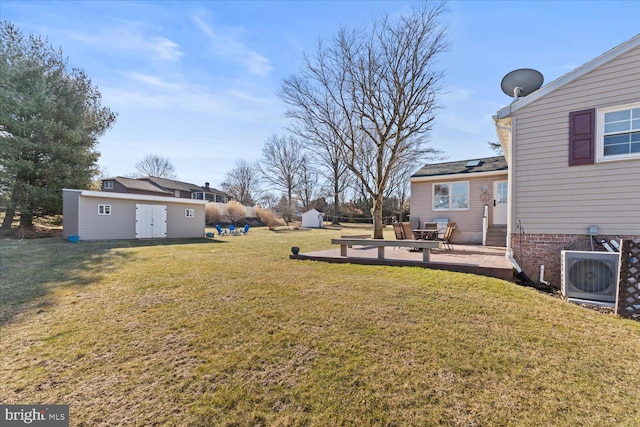 view of yard with an outbuilding, a patio, entry steps, a storage shed, and ac unit