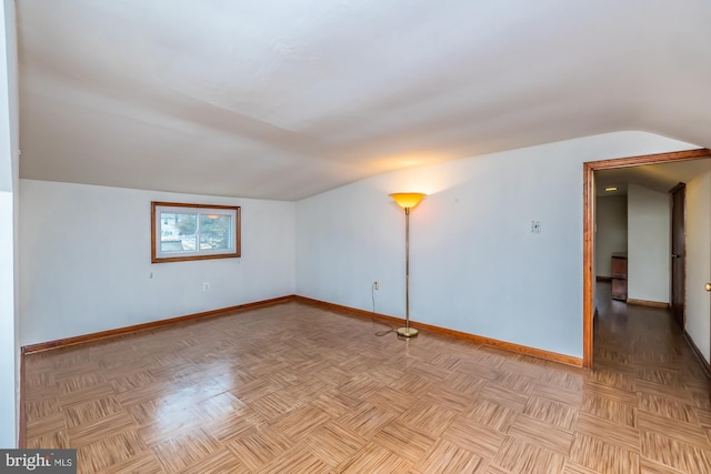 bonus room featuring vaulted ceiling and baseboards