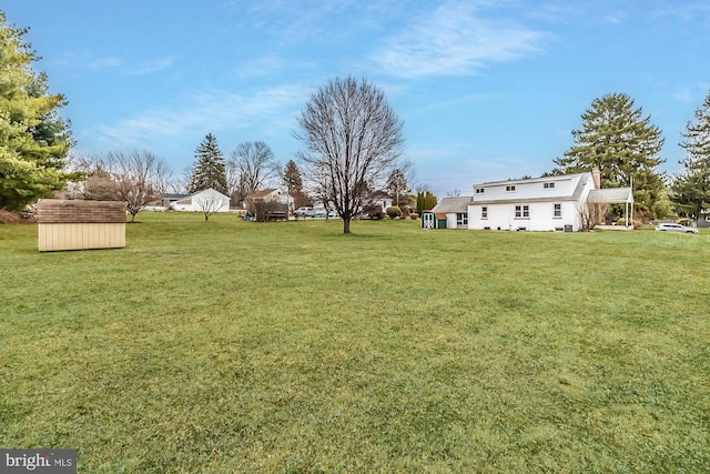 view of yard with a storage shed and an outbuilding