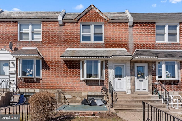 townhome / multi-family property with brick siding