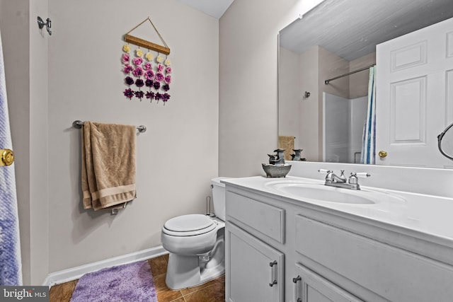 bathroom featuring vanity, curtained shower, toilet, and baseboards