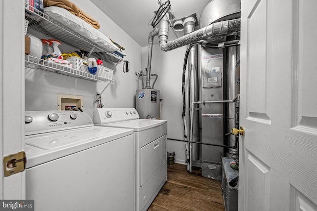 clothes washing area featuring dark wood-style floors, laundry area, washer and dryer, and electric water heater