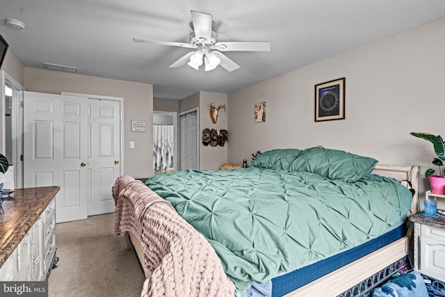 bedroom with visible vents, a ceiling fan, and carpet floors