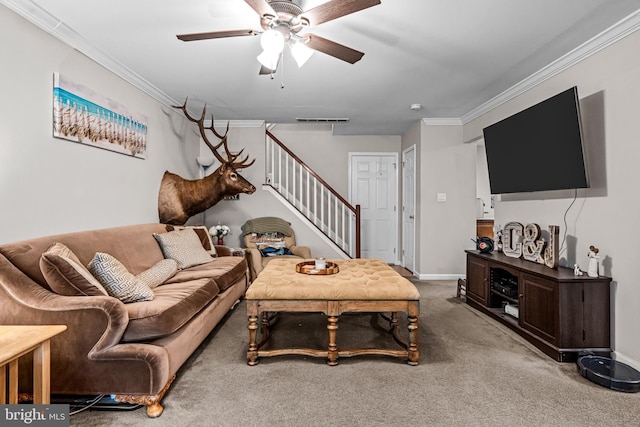 carpeted living room featuring stairway, baseboards, ceiling fan, and crown molding