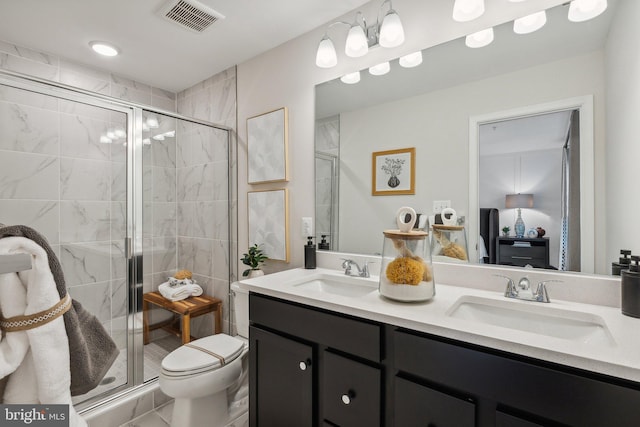 bathroom featuring a shower stall, visible vents, and a sink