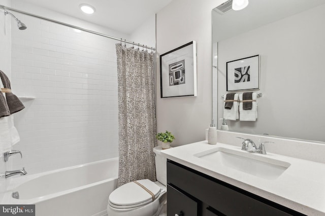 bathroom featuring visible vents, toilet, vanity, and shower / bath combination with curtain