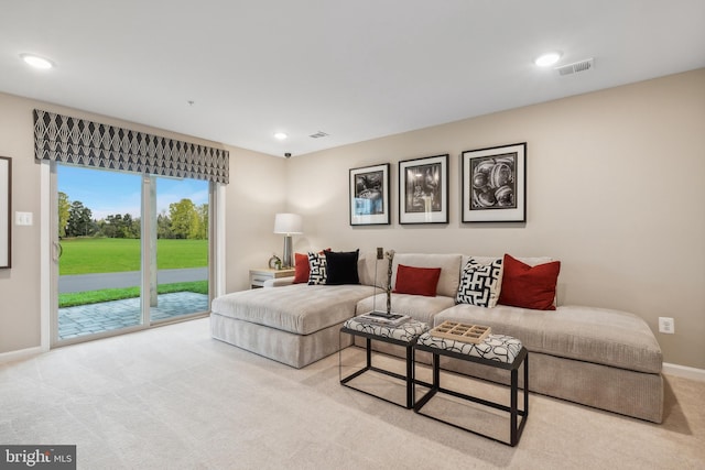 carpeted living area with visible vents, recessed lighting, and baseboards