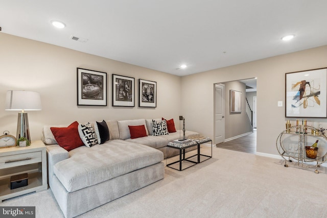 living room featuring visible vents, baseboards, carpet, stairway, and recessed lighting