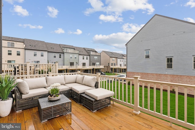 wooden deck featuring an outdoor living space, a lawn, and a residential view