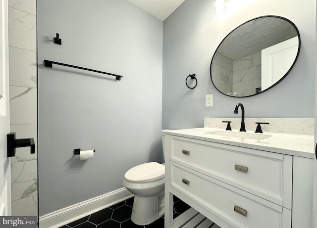 full bathroom featuring tile patterned flooring, baseboards, toilet, vanity, and a textured ceiling