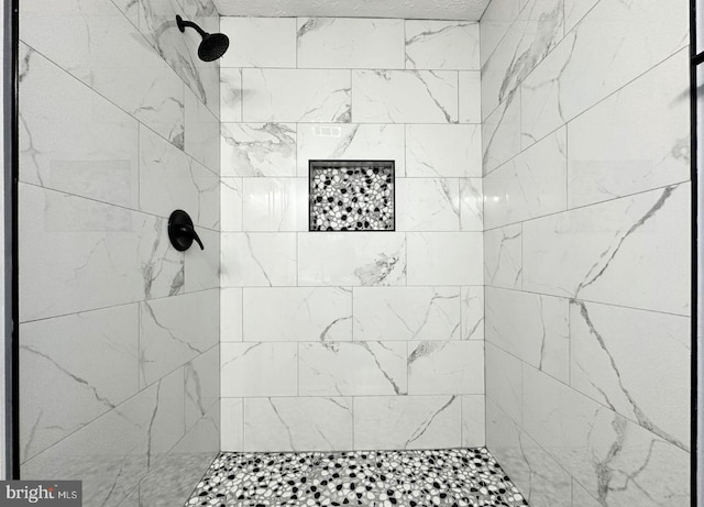 full bath featuring tiled shower