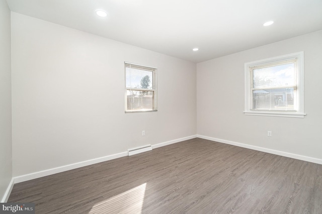 unfurnished room with recessed lighting, baseboards, and wood finished floors