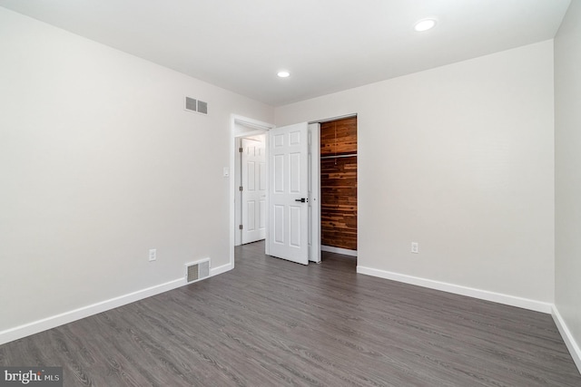 unfurnished bedroom with recessed lighting, baseboards, visible vents, and dark wood-style flooring