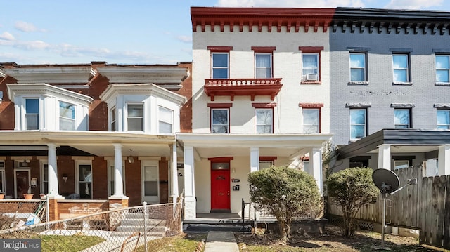 multi unit property featuring brick siding and fence