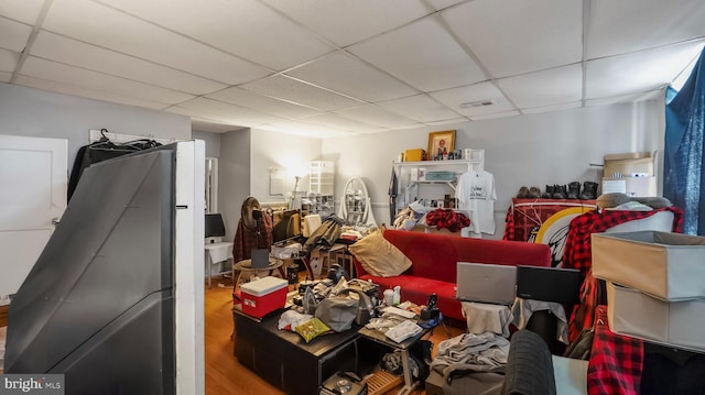 miscellaneous room with a paneled ceiling and wood finished floors