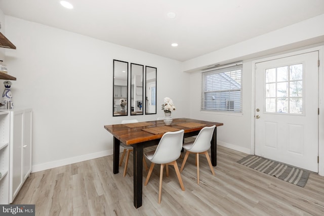 dining space with recessed lighting, baseboards, and light wood finished floors