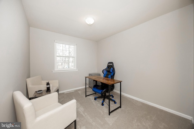 office space with baseboards and light colored carpet