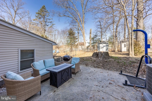 view of patio featuring an outdoor living space and an outbuilding