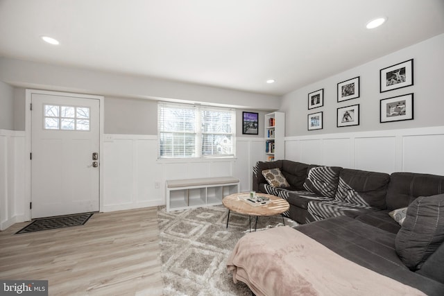 living room featuring light wood finished floors, recessed lighting, and a healthy amount of sunlight