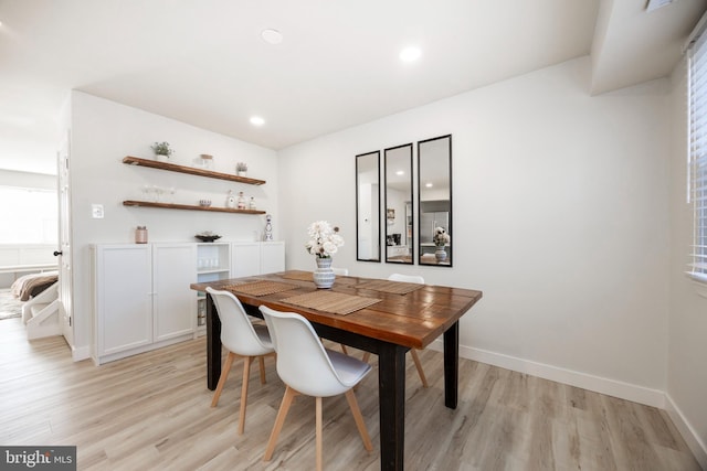 dining room with recessed lighting, baseboards, and light wood-type flooring