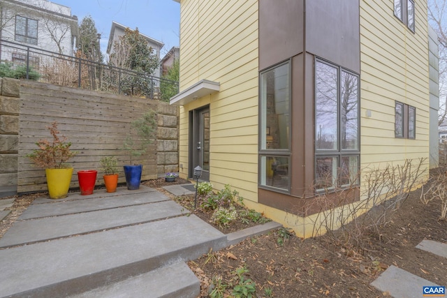 view of side of property featuring fence