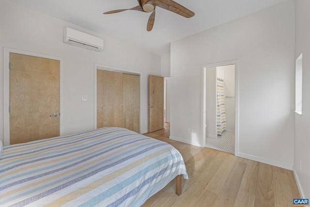 bedroom featuring baseboards, ceiling fan, light wood-type flooring, a closet, and a wall mounted AC