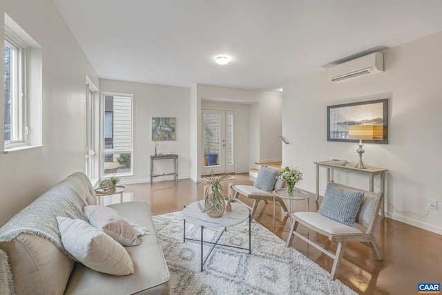 living area featuring french doors, a wall mounted air conditioner, and baseboards