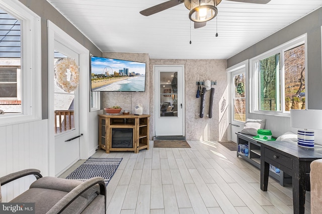 interior space with light wood finished floors and a ceiling fan