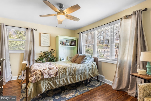 bedroom with ceiling fan, baseboards, and wood finished floors