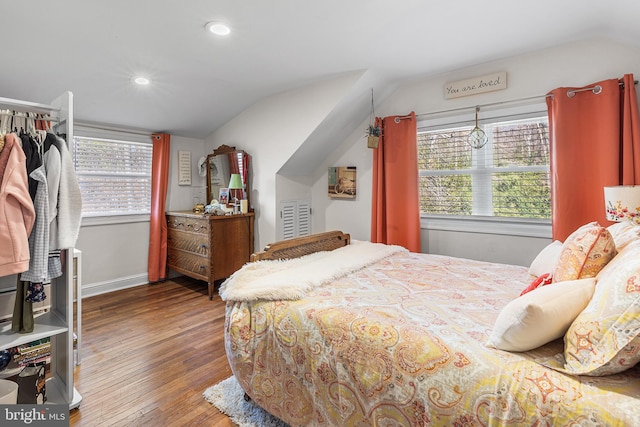 bedroom with vaulted ceiling, recessed lighting, wood finished floors, and baseboards