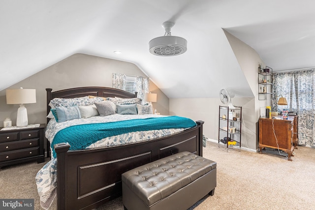 carpeted bedroom featuring baseboards and vaulted ceiling