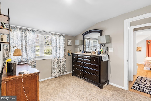 bedroom with vaulted ceiling, carpet, and baseboards