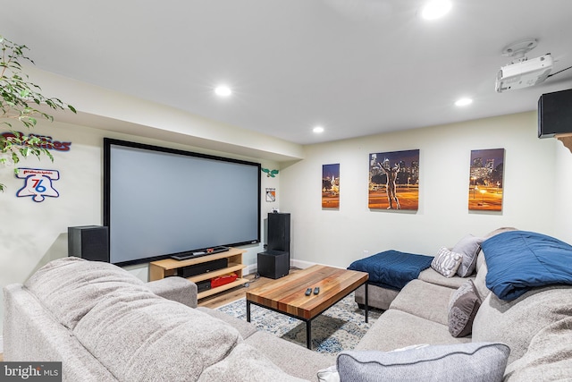 cinema with wood finished floors and recessed lighting