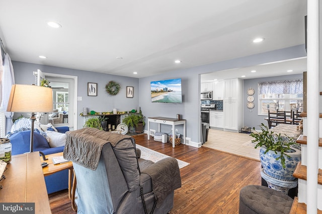 living area featuring recessed lighting, baseboards, and wood finished floors