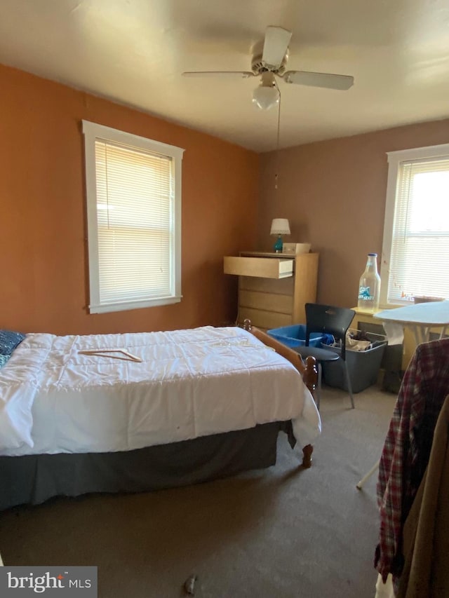 bedroom with ceiling fan and carpet floors