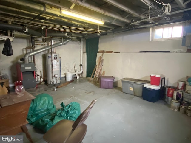 basement featuring water heater and a heating unit