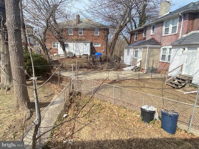 back of property featuring entry steps and fence private yard