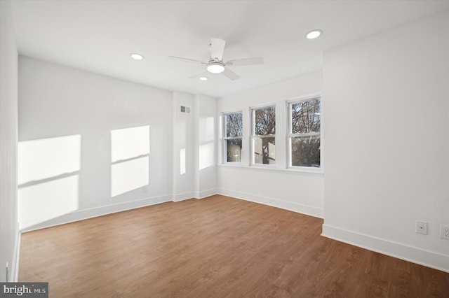 unfurnished room with visible vents, recessed lighting, baseboards, and wood finished floors