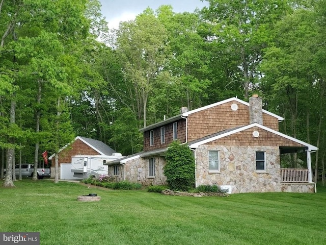 exterior space featuring stone siding, a lawn, and a chimney