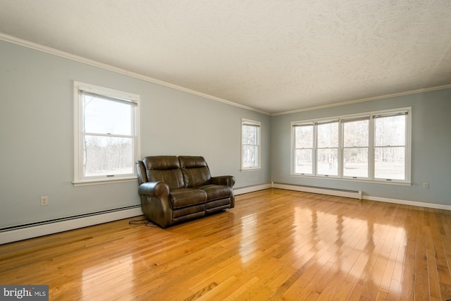 sitting room with a textured ceiling, ornamental molding, and light wood finished floors