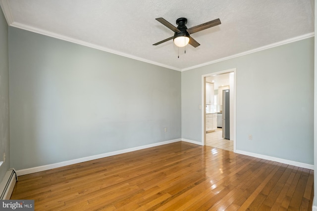 unfurnished bedroom with baseboards, wood-type flooring, baseboard heating, and crown molding