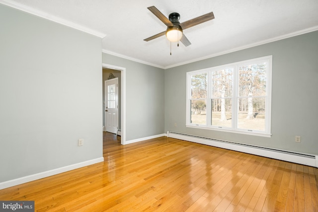 empty room featuring baseboards, light wood finished floors, ceiling fan, crown molding, and baseboard heating