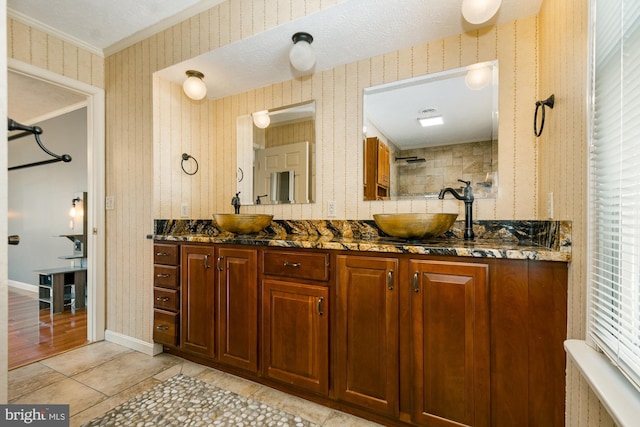 full bathroom featuring tile patterned flooring, wallpapered walls, and a sink