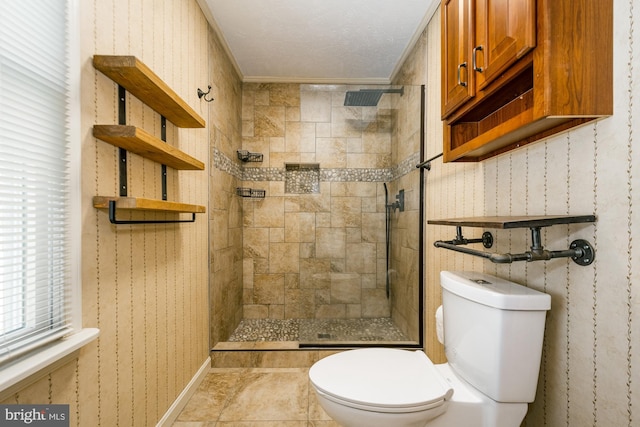 full bathroom with tile patterned floors, wallpapered walls, toilet, and a tile shower